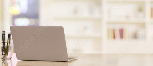 Wallpaper Mural Workspace tabletop with notebook laptop and copy space over blurred office or library background. Torontodigital.ca