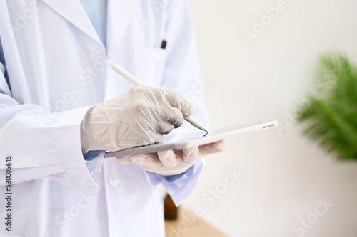 cropped image, Professional doctor records diagnosis symptoms on his medical clipboard.