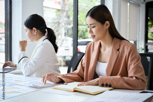 Beautiful and smart Asian businesswoman working in the office