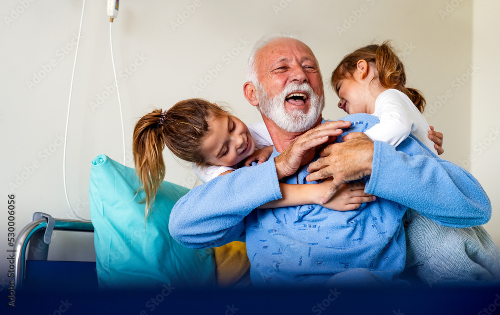 Little girls visiting grandfather in hospital, who is recovering from coronavirus. Little girls visiting grandfather in hospital, who is recovering from coronavirus.