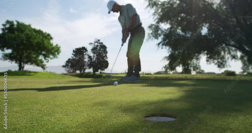 Golf player hitting the ball with his club Golf player hitting the ball with his club