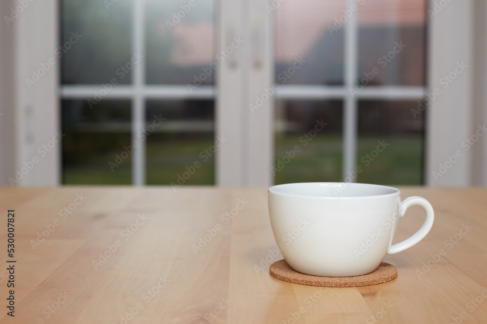 Fototapeta premium blurred background of kitchen and white cup of tea