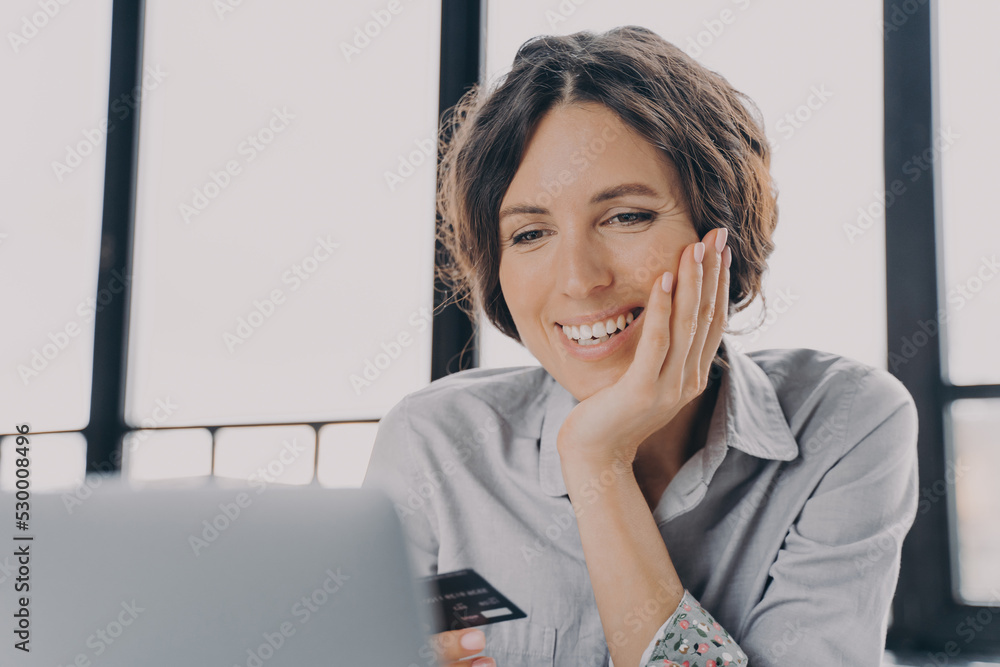 Young happy european woman with credit card enjoying shopping at home Young happy european woman with credit card enjoying shopping at home