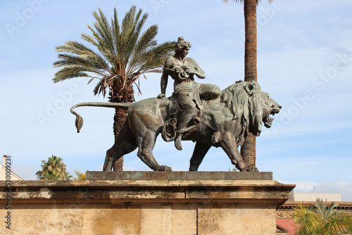statue of a lion and a mythological character at the massimo theater in palermo in sicily (italy)  photo