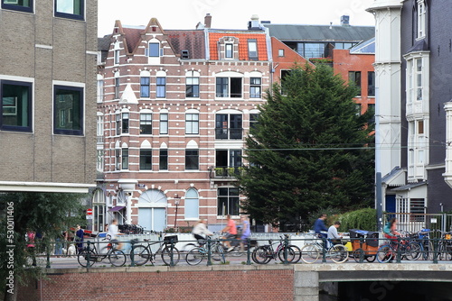 Amsterdam Weteringschans Street View with Historic House Facades, Parked Bicycles and People, Netherlands photo