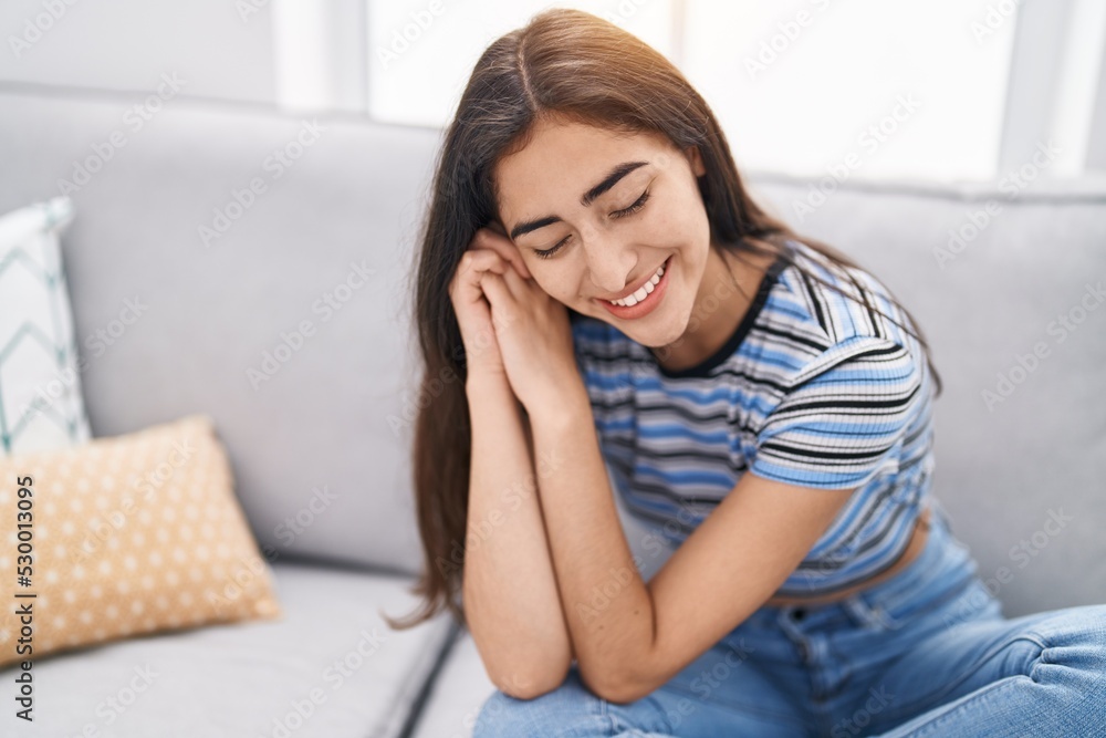 Young hispanic girl smiling confident sitting on sofa at home Young hispanic girl smiling confident sitting on sofa at home