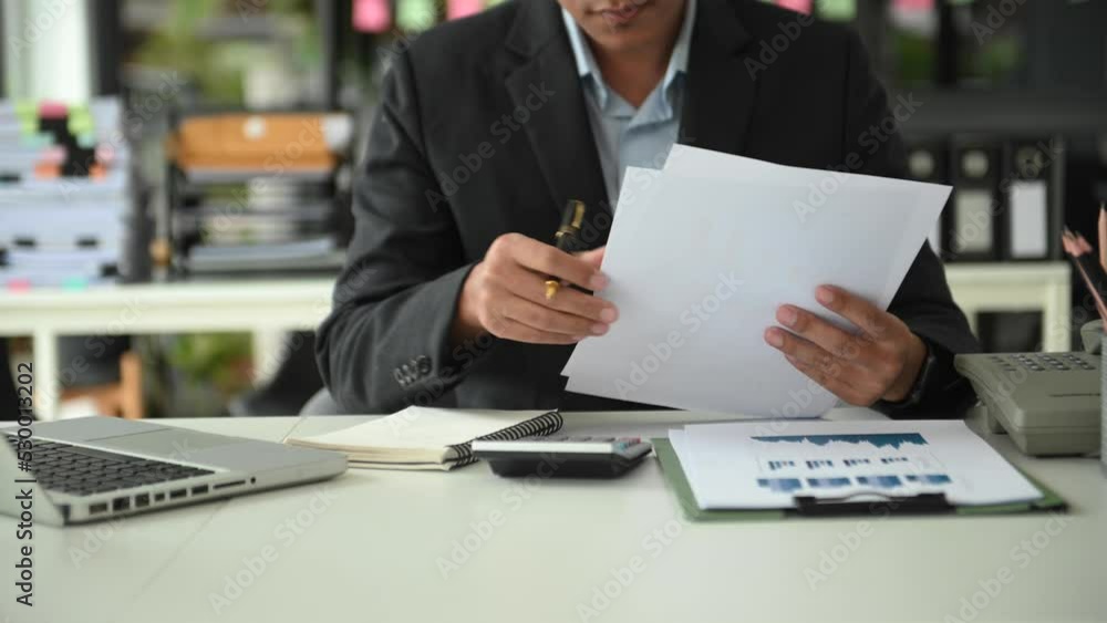 businessman working on desk office with using a calculator to calculate and notepad the numbers, finance accounting concept businessman working on desk office with using a calculator to calculate and notepad the numbers, finance accounting concept