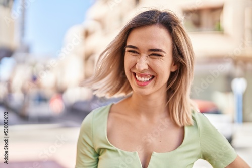 Young woman smiling confident looking to the side at street Free Download Young woman smiling confident looking to the side at street - GFXLoad