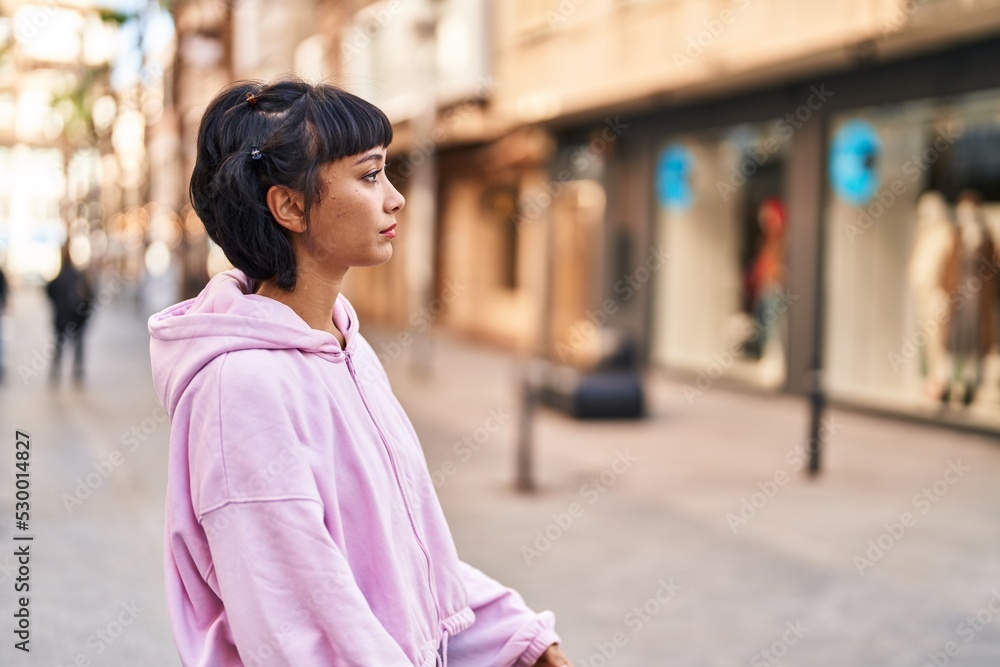 Young woman standing with relaxed expression at street Young woman standing with relaxed expression at street