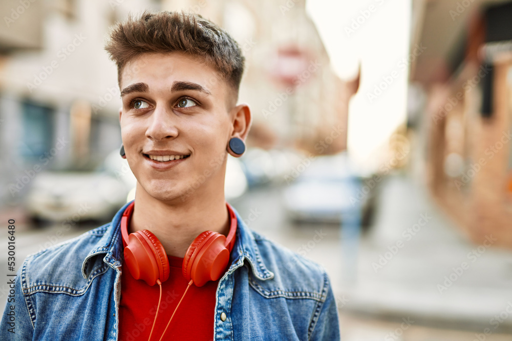 Young caucasian guy smiling at the city Young caucasian guy smiling at the city