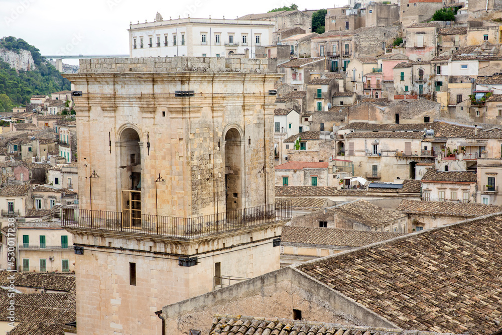Closeup of bell tower of the basilica of San Pietro, a religious building in Modica, in the province of Ragusa, Italy. This church is considered a masterpiece of the Italian Baroque.