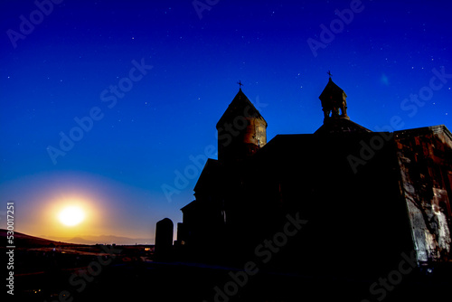 Night landscape, church on the background of the night sky. The shining stars and the old monastery