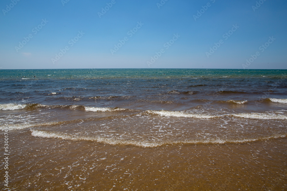 Seafront of Santa Maria del Focallo in Sicily, Italy. The waves of the sea and the beach are empty. Seafront of Santa Maria del Focallo in Sicily, Italy. The waves of the sea and the beach are empty.
