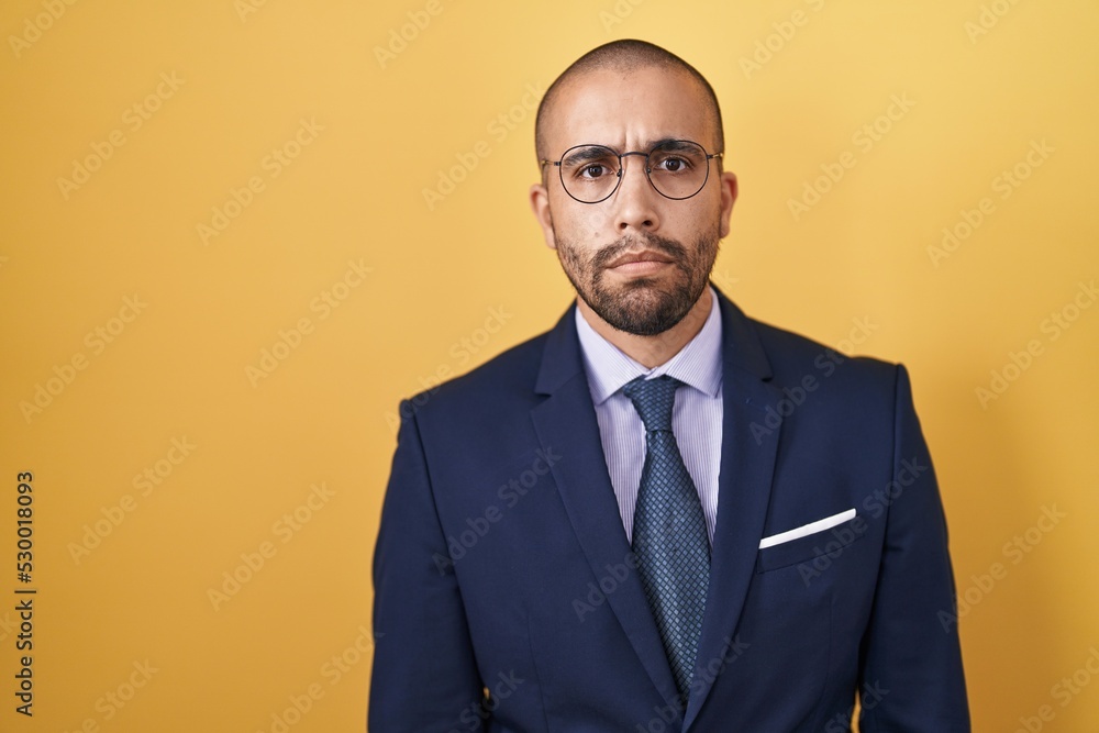Hispanic man with beard wearing suit and tie skeptic and nervous, frowning upset because of problem. negative person. Hispanic man with beard wearing suit and tie skeptic and nervous, frowning upset because of problem. negative person.