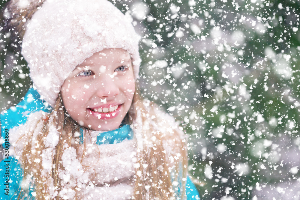 Smiling little girl with blond hair in snowfall. Smiling little girl with blond hair in snowfall.