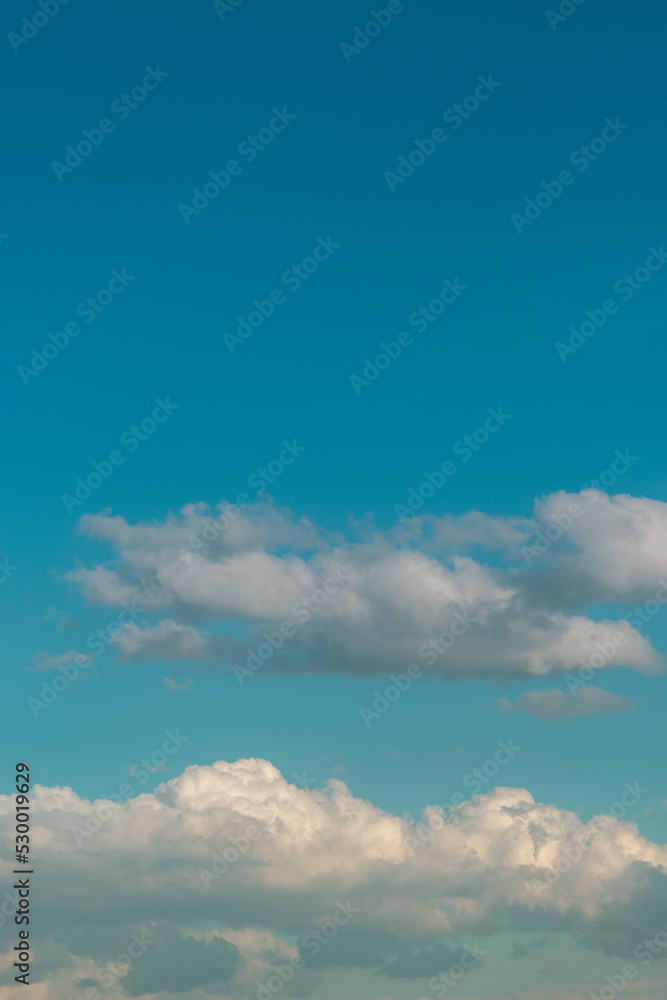 Cover page with soft blue sky with illuminated clouds as a background.