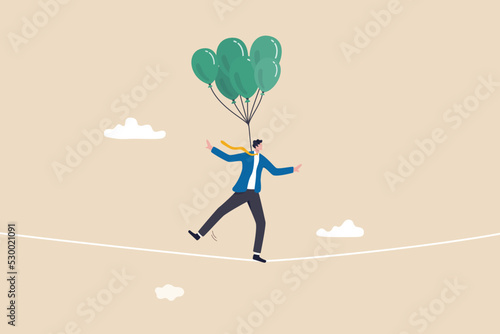 Risk management control or assessment on uncertainty, plan to survive in crisis or danger situation, reduce loss or disaster concept, businessman acrobat walk on the rope with balloons to reduce risk.