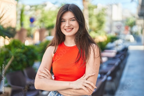 Young caucasian woman standing with arms crossed gesture at street Free Download Young caucasian woman standing with arms crossed gesture at street - GFXLoad