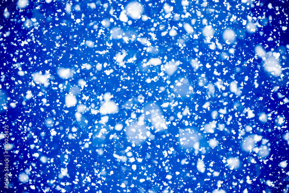 Shining snowflakes falling from the dark blue sky. Shining snowflakes falling from the dark blue sky.
