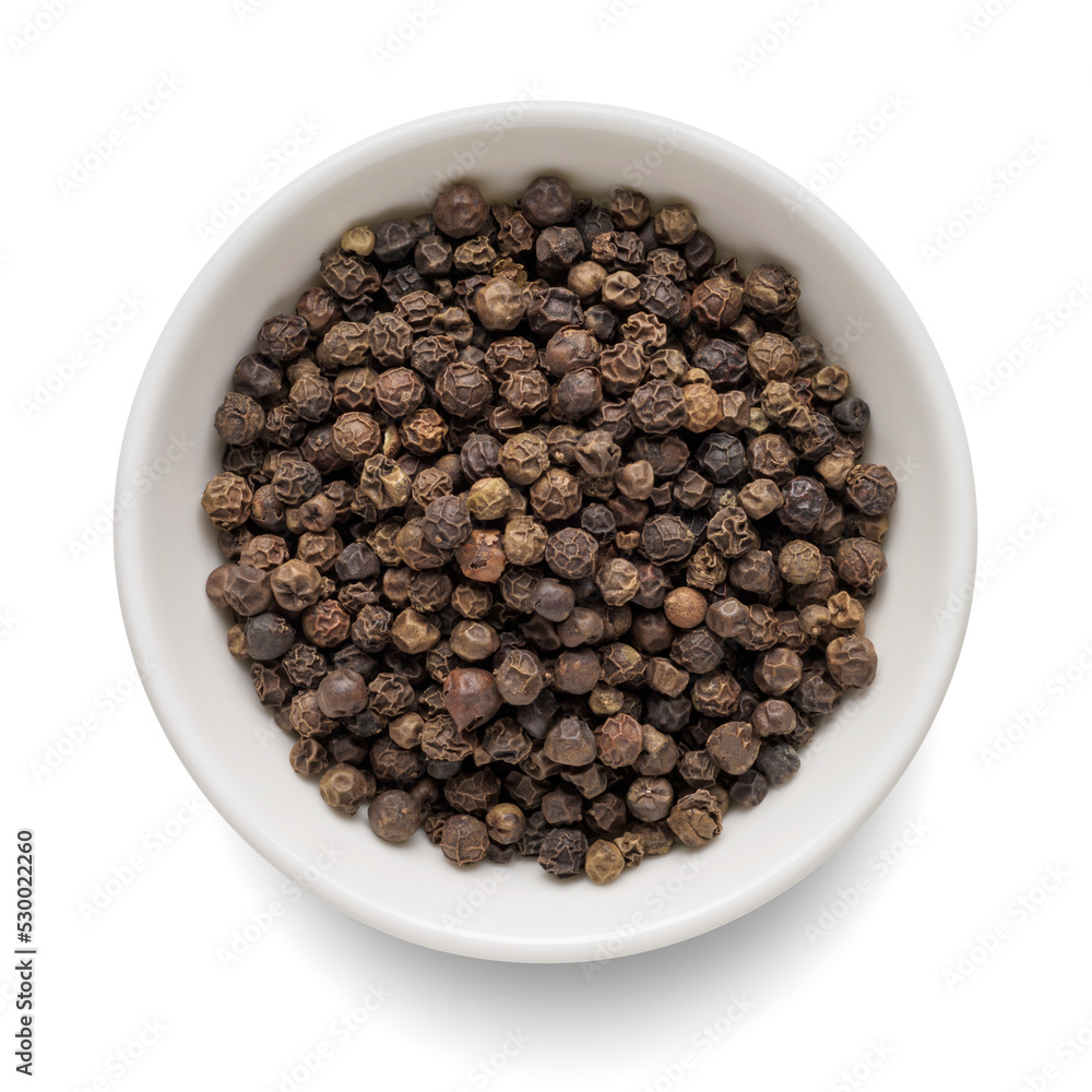 Black pepper in white bowl isolated on white. Top view.