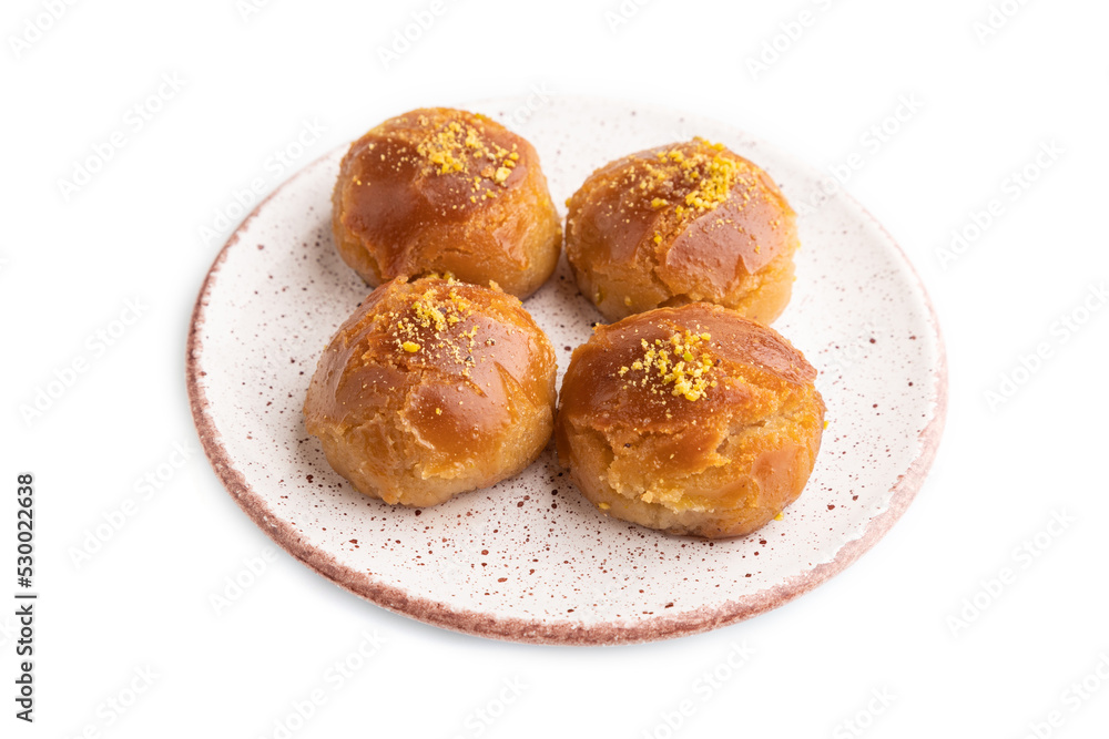 Traditional turkish dessert sekerpare with almonds and honey isolated on white, side view.