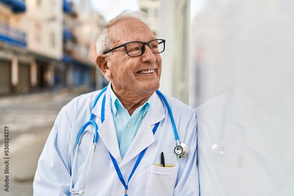 Senior man wearing doctor uniform standing at street Senior man wearing doctor uniform standing at street