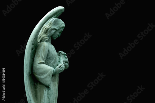 Profile image of an ancient statue of guardian angel. Copy space for design.