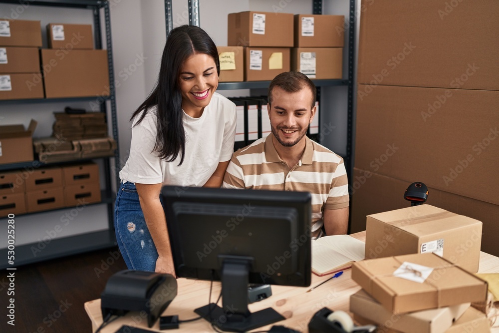 Young hispanic people working at small business ecommerce looking positive and happy standing and smiling with a confident smile showing teeth Young hispanic people working at small business ecommerce looking positive and happy standing and smiling with a confident smile showing teeth
