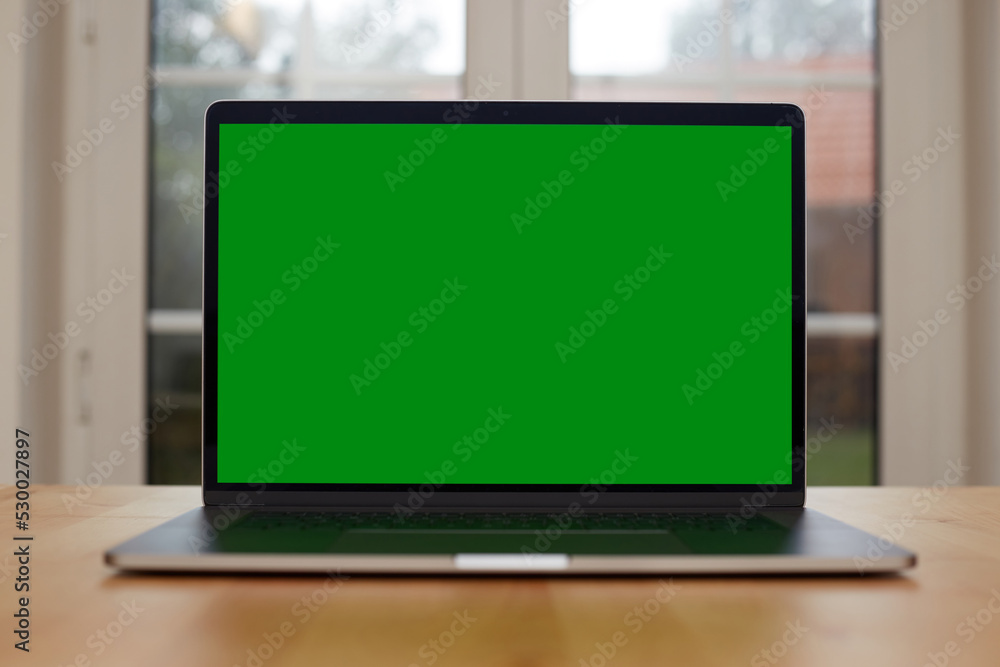 Laptop with blank screen on white table with mouse and smartphone. Home interior or office background Laptop with blank screen on white table with mouse and smartphone. Home interior or office background