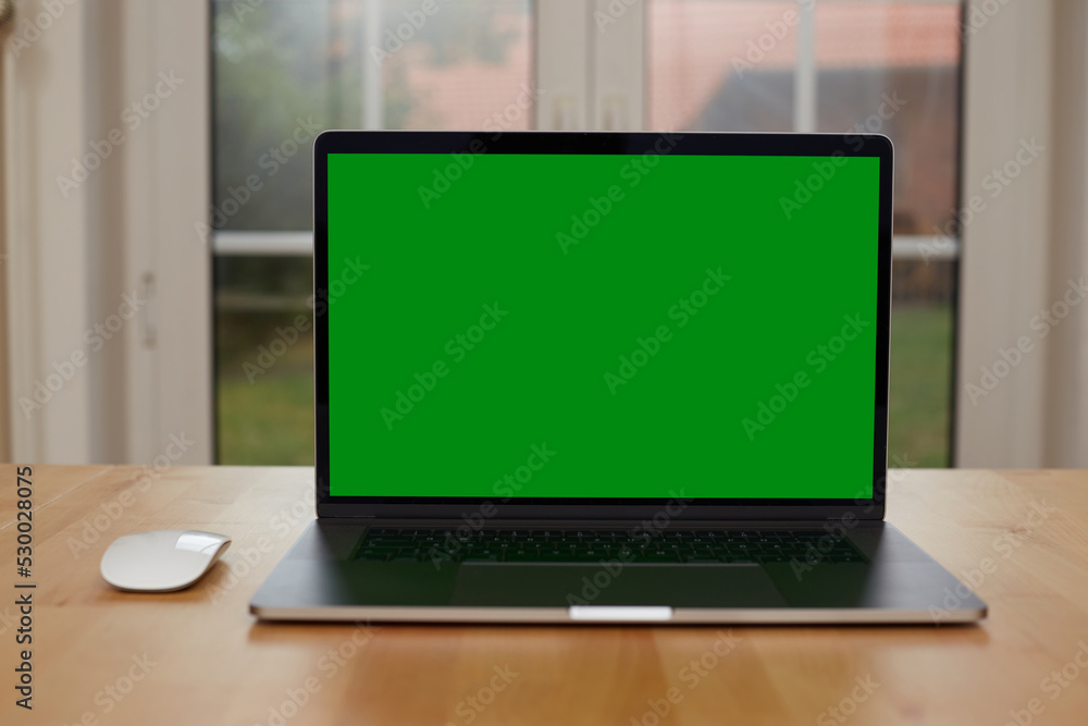 Laptop with blank screen on white table with mouse and smartphone. Home interior or office background Laptop with blank screen on white table with mouse and smartphone. Home interior or office background
