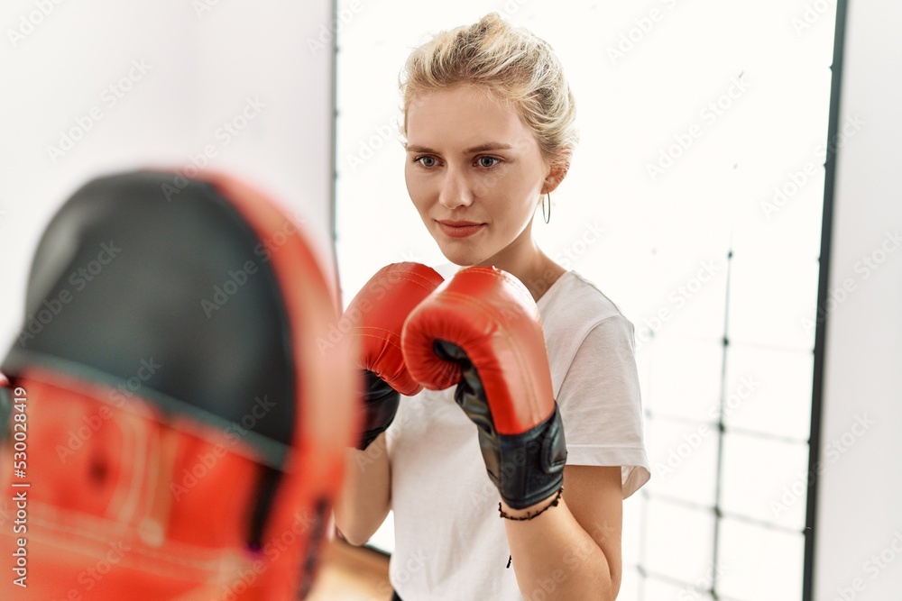 Young couple training boxing at sport center.