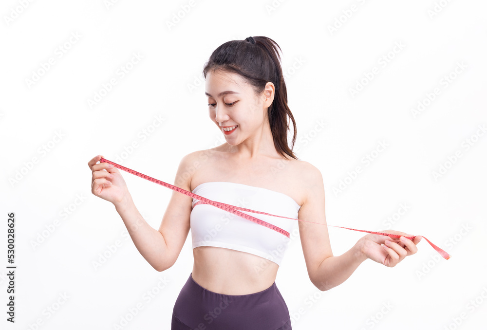 Attractive women in white sports underwear measure their breasts Attractive women in white sports underwear measure their breasts