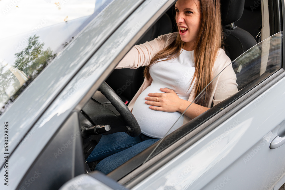 Pregnant driving car. Young smiling pregnancy woman driving car. Safety pregnant young mom driving concept. Pregnant driving car. Young smiling pregnancy woman driving car. Safety pregnant young mom driving concept.
