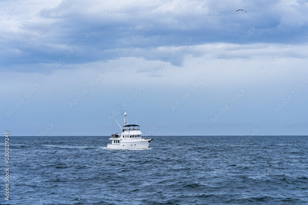 White fishing ship in the atlantic ocean in cloudy weather White fishing ship in the atlantic ocean in cloudy weather