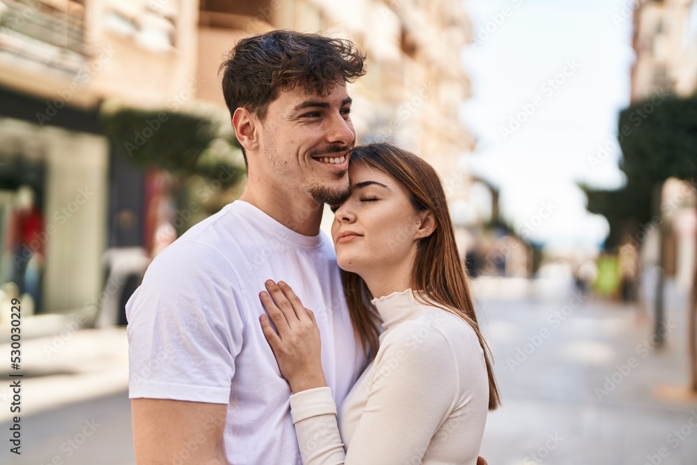 Mand and woman couple hugging each other at street Mand and woman couple hugging each other at street