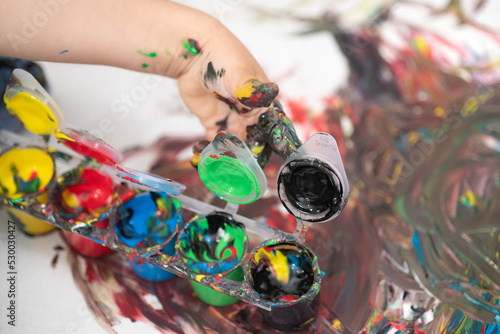 close up of a child's hand covered in paint, hand painting