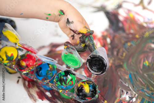 Close up of a child's hand covered in paint, hand painting