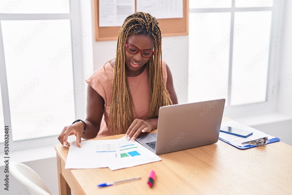 Obraz premium African american woman business worker using laptop reading document at office