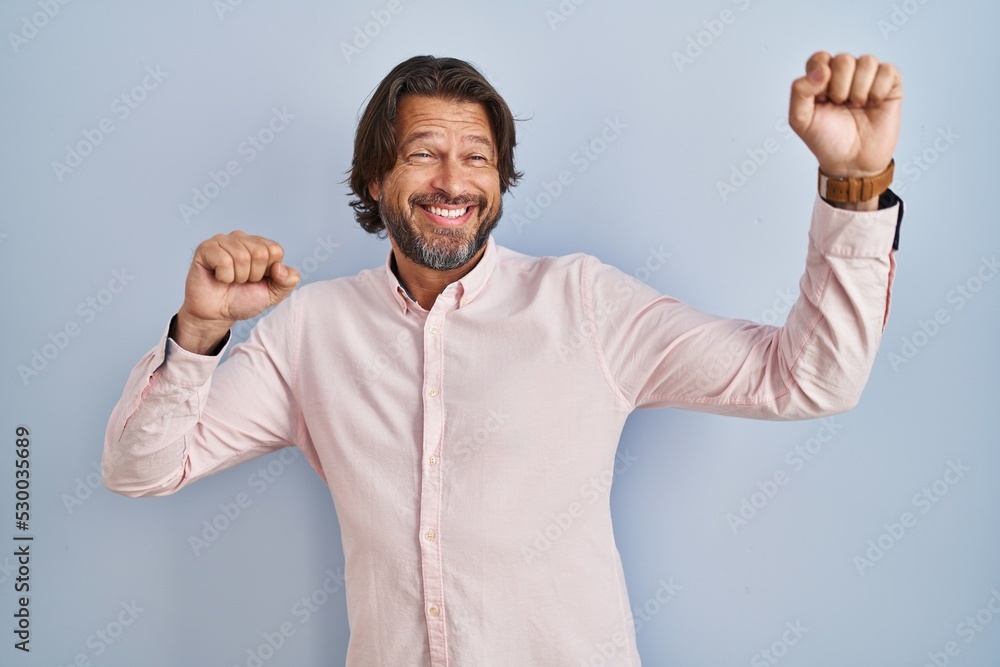Handsome middle age man wearing elegant shirt background dancing happy and cheerful, smiling moving casual and confident listening to music Handsome middle age man wearing elegant shirt background dancing happy and cheerful, smiling moving casual and confident listening to music
