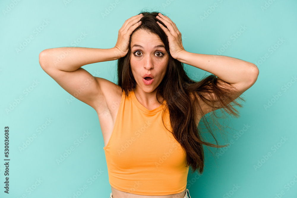 Young caucasian woman isolated on blue background surprised and shocked. Young caucasian woman isolated on blue background surprised and shocked.