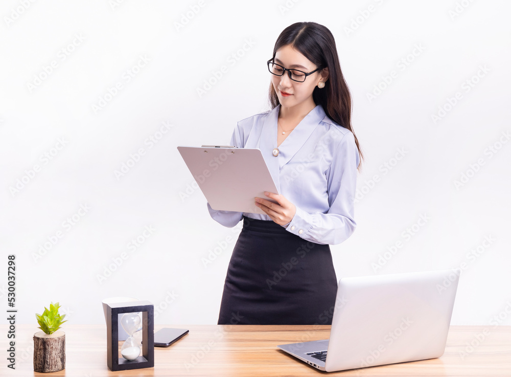 A business woman standing at her desk in a short black dress A business woman standing at her desk in a short black dress