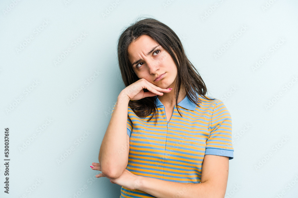 Young caucasian woman isolated on blue background tired of a repetitive task. Young caucasian woman isolated on blue background tired of a repetitive task.