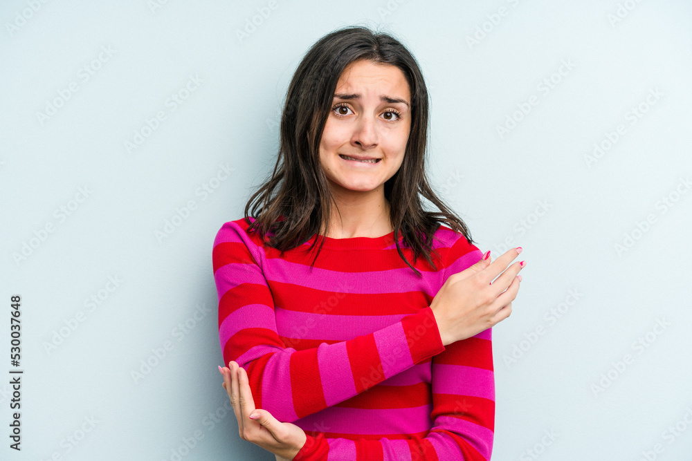 Young caucasian woman isolated on blue background massaging elbow, suffering after a bad movement. Young caucasian woman isolated on blue background massaging elbow, suffering after a bad movement.