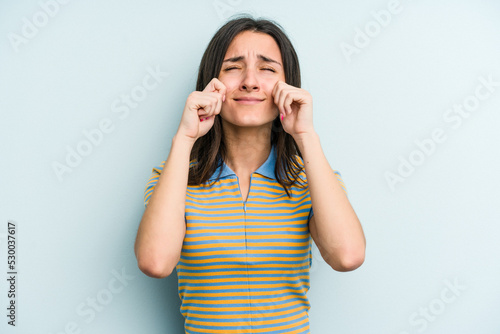 Young caucasian woman isolated on blue background whining and crying disconsolately.