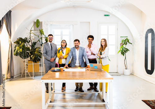 Group of business people standing in office.