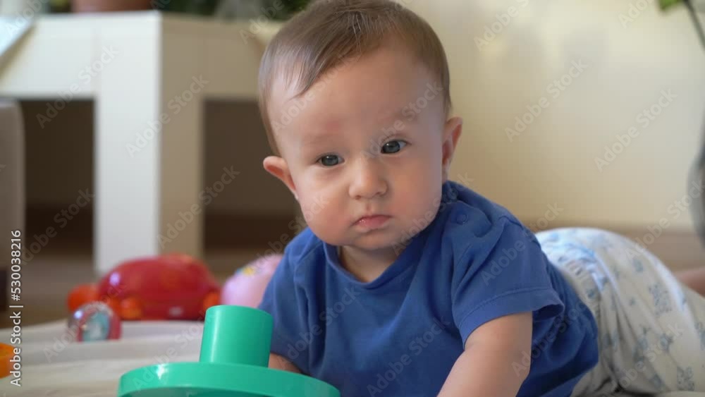 Baby child playing with toy and biting toy. Baby child playing with toy and biting toy.