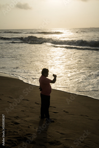 A person talking by video call in the beach of Bay of Bengal in Chennai