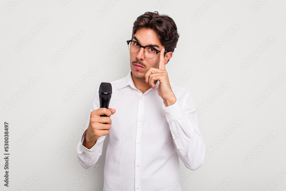 Young hispanic singer man isolated on white background pointing temple with finger, thinking, focused on a task. Young hispanic singer man isolated on white background pointing temple with finger, thinking, focused on a task.