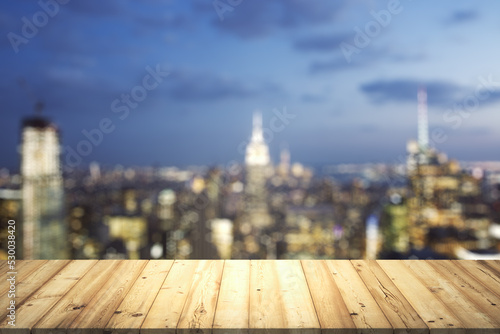 Table top made of wooden dies with beautiful blurry cityscape at twilight on background, mockup © Pixels Hunter