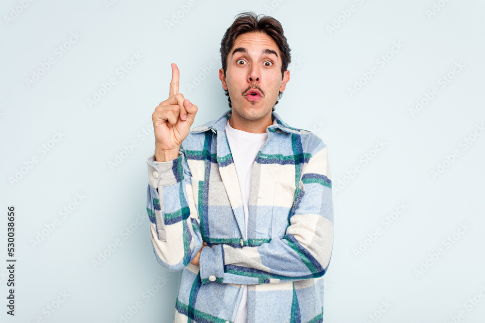 Young hispanic man isolated on blue background having some great idea, concept of creativity. Young hispanic man isolated on blue background having some great idea, concept of creativity.
